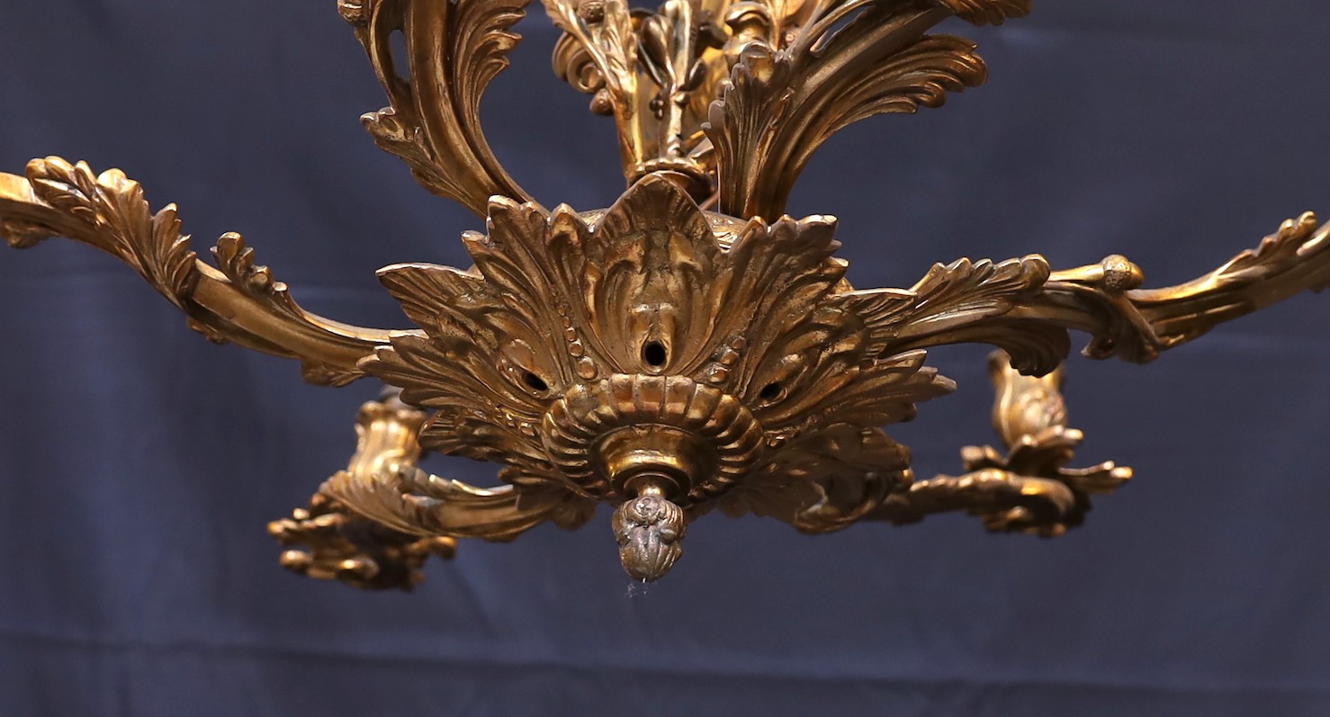 An early 20th century French gilt bronze rococo six light chandelier, height 59cm. width 66cm